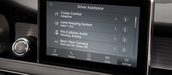 Car dashboard display showing driver assistance features: Cruise Control, Lane Keeping, Pre-Collision, and Rear View Camera.