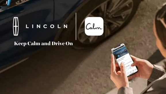 Person holding smartphone near a Lincoln vehicle, featuring Lincoln and Calm logos with "Keep Calm and Drive On" text.