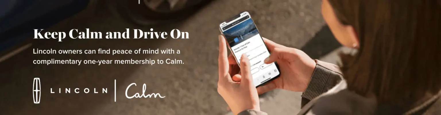 Person using a smartphone with Calm app beside text promoting a one-year membership for Lincoln owners.