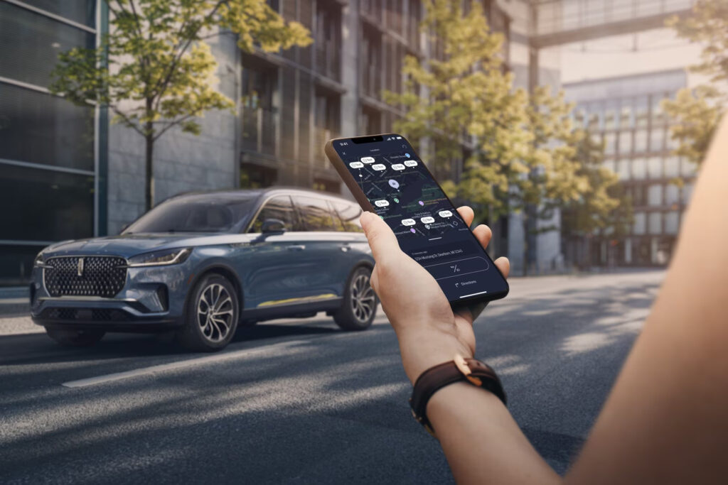 Person holding smartphone with map app in front of a parked SUV on an urban street.
