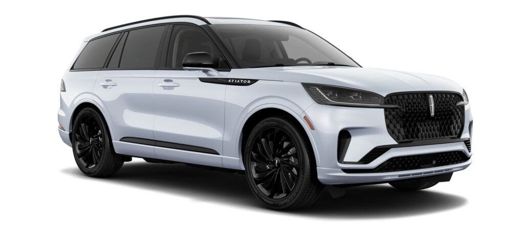White Lincoln Aviator SUV with black accents, sleek design visible from side and front angles.