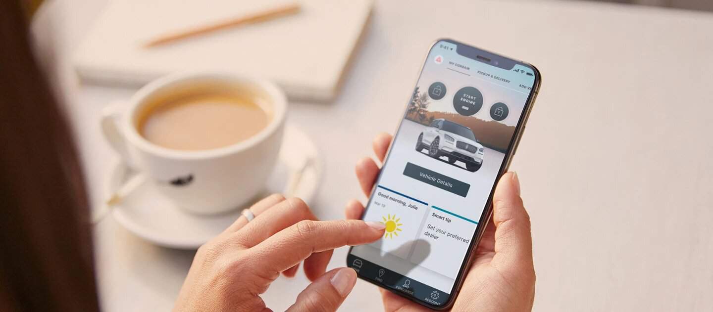 Person using The Lincoln Way app on a smartphone while having coffee